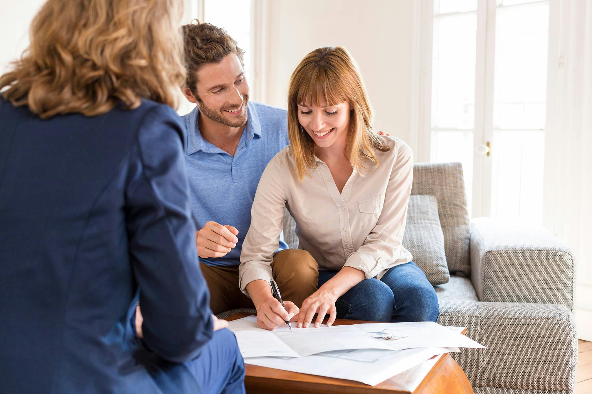 young couple owners meeting real estate agent for house investment